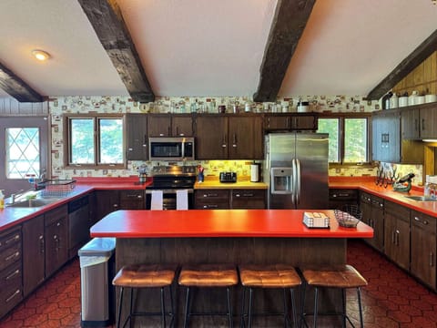 View of the full - well equipped kitchen and the center island eat-in seating for four, room for multiple cooks, and with visibility across the entire great room, dining, living room, entertainment space