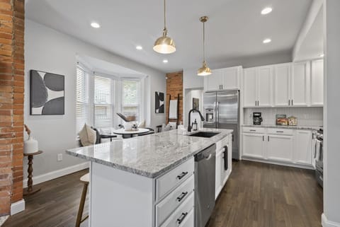 Spacious kitchen with granite island and stainless steel appliances - Pendant lights brighten the cooking space with a modern touch - Enjoy meals or conversations at the island or the nearby breakfast nook