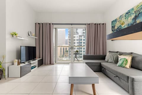 Living Room: Bright space with modern decor and stunning city views—perfect for relaxation or fun!