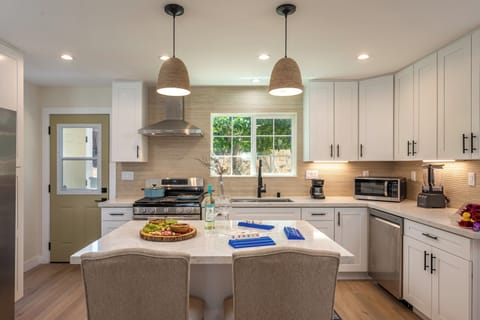 Modern kitchen with island seating, stainless appliances, and style