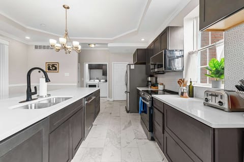 Welcome to your new favorite gathering spot! Whether you're whipping up a cozy breakfast or hosting a dinner, this stylish kitchen is your canvas.