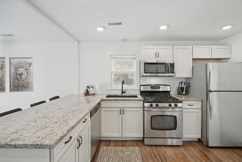 Whip up a meal with ease in the fully stocked kitchen featuring granite countertops, stainless appliances, and bar seating for the crew.