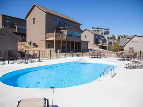 Family-friendly resort pool just steps from the cabin — perfect for swimming, splashing, and relaxing on the provided loungers.