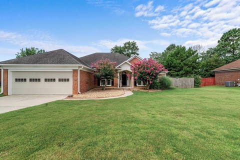 A warm welcome awaits with a spacious, inviting front yard.