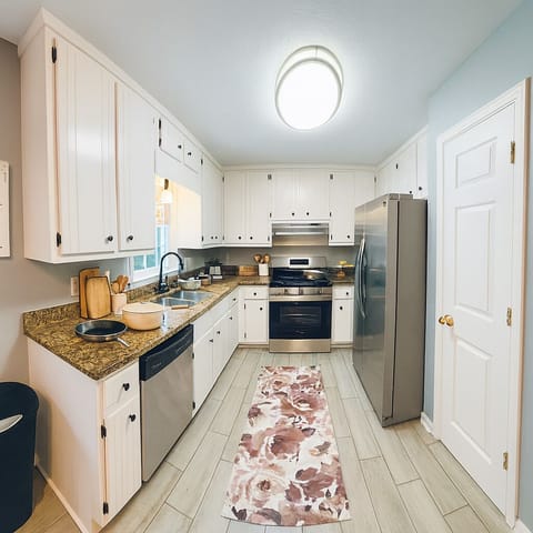 Bright chef-ready kitchen with stainless appliances and stone counters