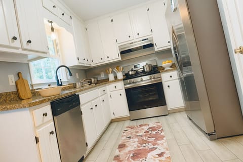 Bright chef-ready kitchen with stainless appliances and stone counters