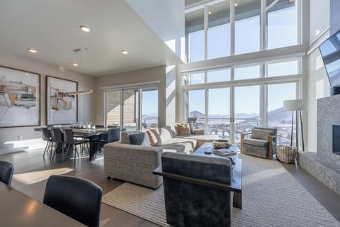 Floor-to-ceiling windows offer stunning views of the mountains and Village.