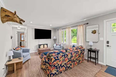 Bright living room with seating and large TV