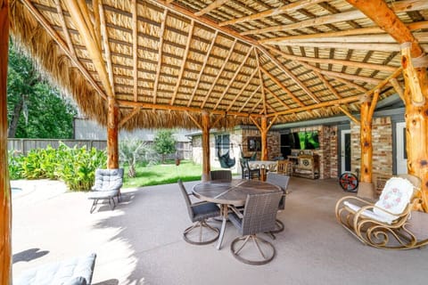 Spacious tiki cabana with plenty of seating — the ultimate spot for outdoor dining, lounging, and enjoying poolside relaxation.