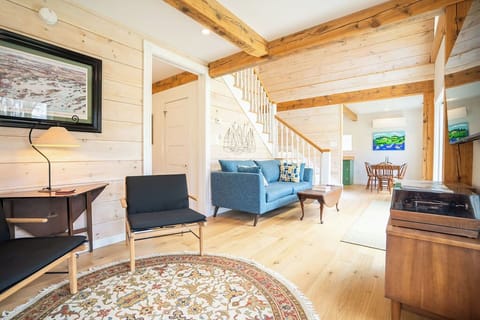 The comfortable living room has striking timber-framed beams.