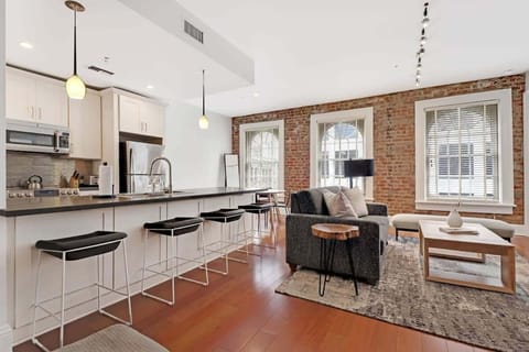 The living room with its natural lighting offers a perfect place to watch a movie with family and friends.