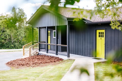 Paved path leads to the ADA-accessible entrance with a yellow door.