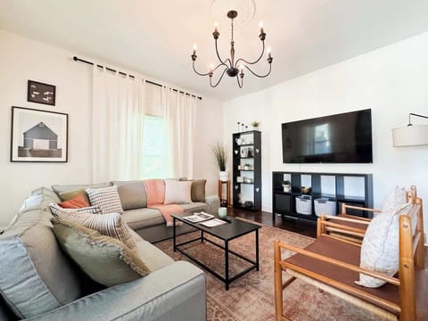 Large sectional couch and a 65" TV in the living room.