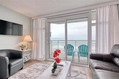 Sliding glass doors open to a private oceanfront balcony with sweeping views.