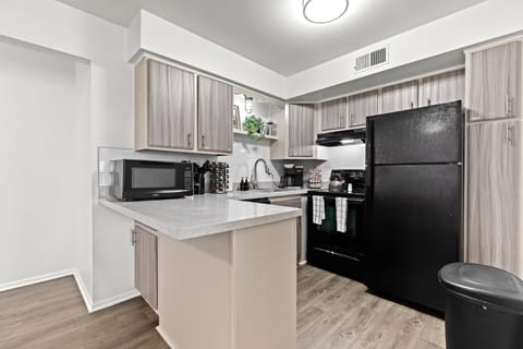 Cook with ease in this sleek kitchen, stocked with a full knife set, spice rack, and all the everyday essentials.