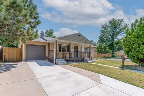 Exterior of home with spacious driveway and plenty of parking
