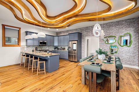 ✨ Cook, dine, and unwind in this chef’s dream kitchen with chic dining vibes and glowing ceilings! 🍷🍽️