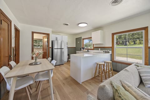 Stylish, sunlit kitchen and dining space with modern touches and cozy charm.