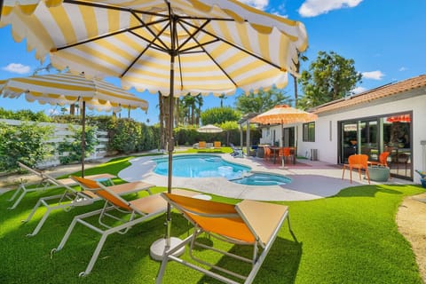 Soak up the sun in your private backyard oasis with a sparkling pool and sun loungers.