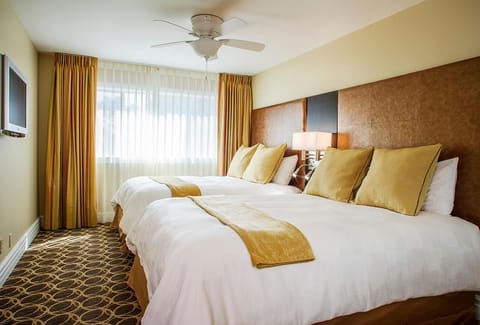 Sink into layered bedding in a sunlit, serene room.