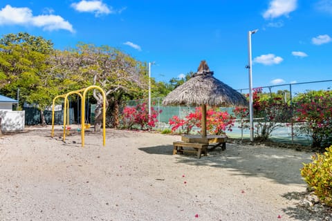 Let kids burn energy on swings near colorful tropical blooms.