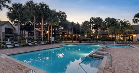 Evening view of the pool with ambient lighting