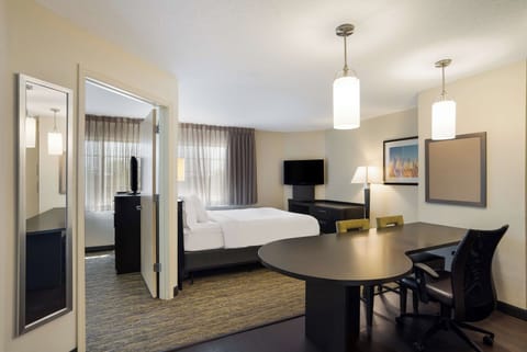 Unwind in a spacious suite with cozy bed and workspace.