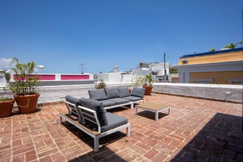 Expansive rooftop terrace with seating and city views