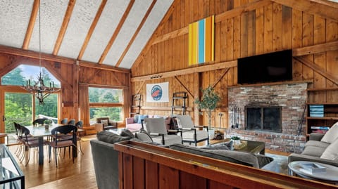 Post and beam great room with fireplace, two seating areas, dining table for 10