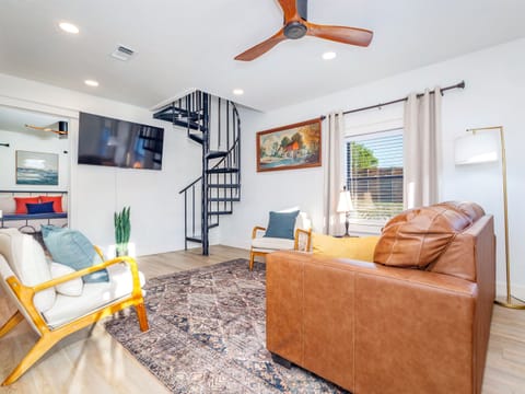 Cozy up and relax in the inviting living space, with a spiral staircase that leads to the second loft bedroom.