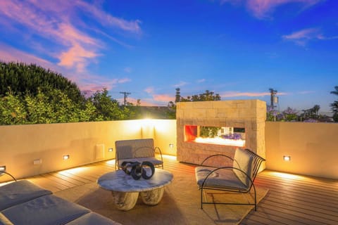 A peaceful backyard and a rooftop deck with an outdoor kitchen and a fireplace. Every detail is designed for a truly unforgettable stay.