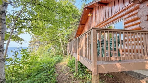 Charming lakeside cabin nestled among birch trees, with a private deck overlooking the water. The property offers direct access to nature trails and serene waterfront views.