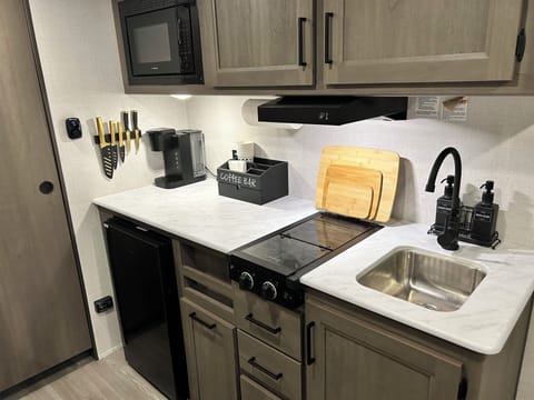 The kitchen, with a stove, fridge and Keurig coffee maker.