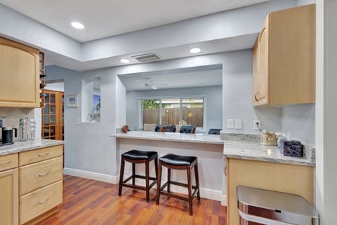 Kitchen overlooks a light-filled Florida sunroom.
