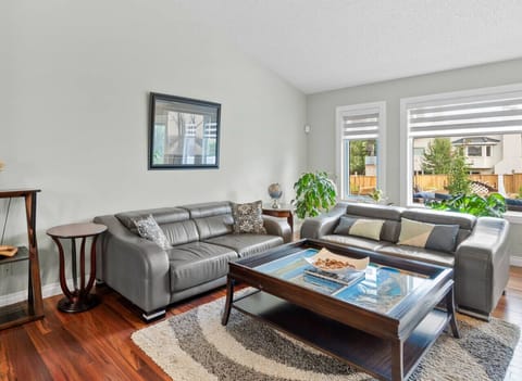 Living room on the main floor with a gas-lit fireplace,. Smart TV and cozy seating options.