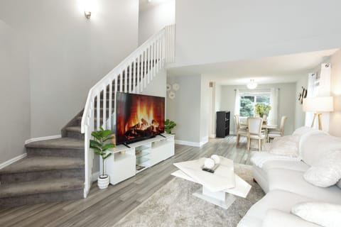 Living room with sofa bed (pull out couch) and 75 inch TV