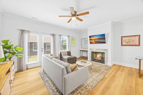 Fireside comfort meets modern charm — unwind in this cozy, light-filled living room after a day in town.
