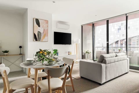 A tastefully furnished living and dining area with a 3-seater sofa bed that folds out to a double.
