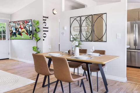 Your dining area effortlessly transitions from meals to movie nights with the discreetly placed television.