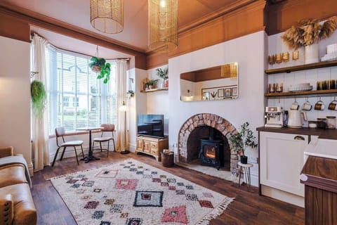 A beautiful, grand fireplace at the heart of the living space.