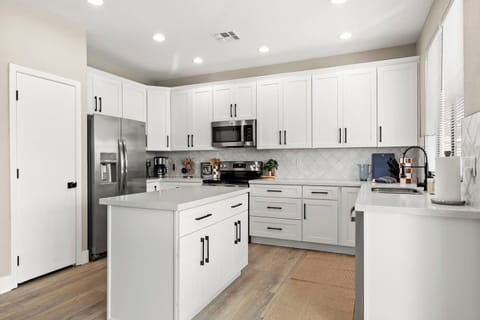 Enjoy preparing meals for loved ones in a modern and well-equipped kitchen with stainless steel appliances.