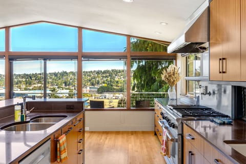Light-filled living space with large windows and a cozy atmosphere on the main level of the house.