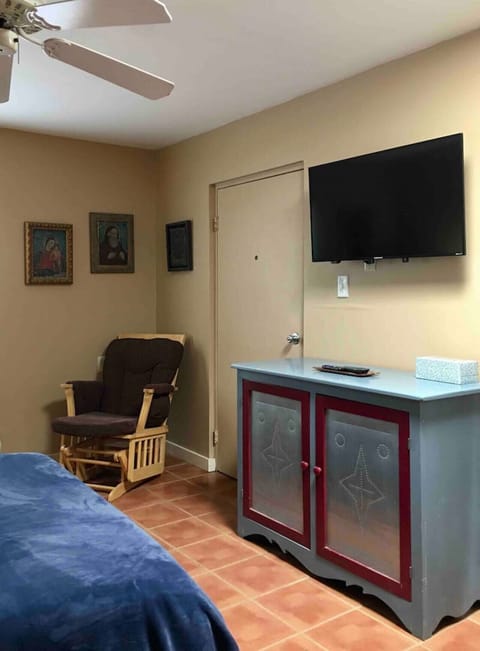 Bedroom - Front Door, Queen Bed, Rocking Chair, TV, and Storage Space