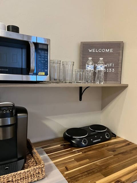 Kitchenette - Glassware, WIFI Sign, and Complimentary Water Bottles