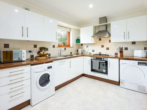 Kitchen, Interior Design, Flooring, Kitchen Appliance, Countertop, Major Appliance, Floor, Wood, Ceiling, Cabinetry