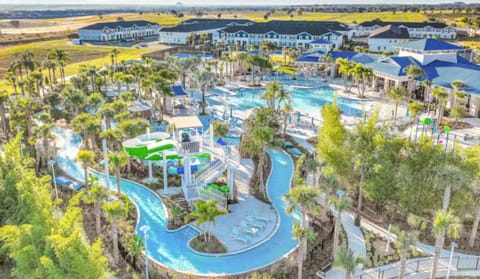 Aerial shot of the resort’s vibrant water park featuring slides, pools, and lush greenery.