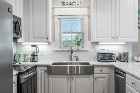 Coastal-inspired kitchen with modern amenities and small appliances for your convenience.
