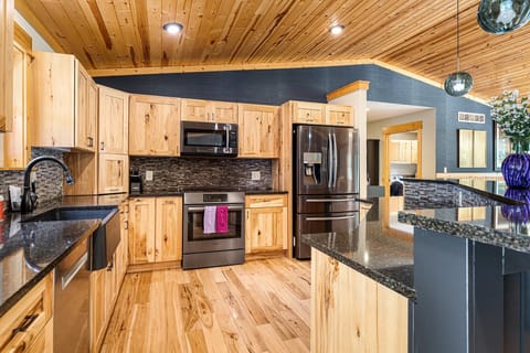 Kitchen: Chef's kitchen and dining area with forest views