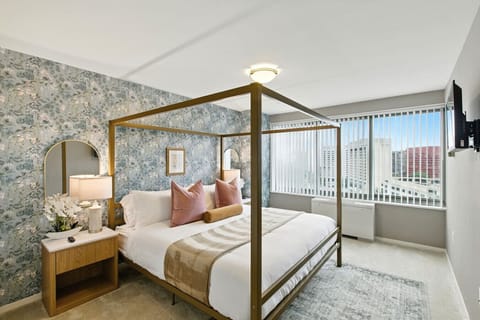 Close the door, pull the blackout shades, and disappear into a king canopy bed wrapped in botanical wallpaper — your private retreat after every D.C. day.