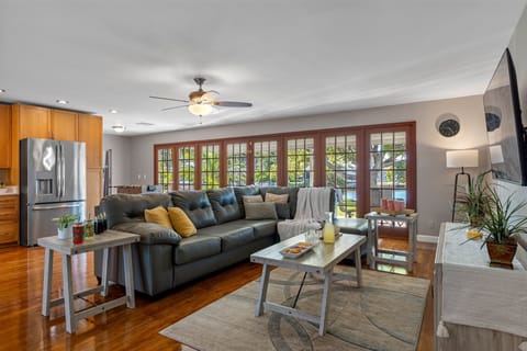 Featuring gleaming hardwood floors, a neutral color palette, and stylish furnishings, this living space balances modern design with homey comfort.
